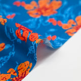 Cotton poplin printed stylized flower orange turquoise background