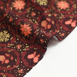 Popeline de coton imprimée poinsettias et nœuds orange fond marron