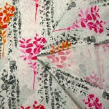 Cotton poplin printed with pink and orange foliage on a light gray background