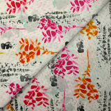 Cotton poplin printed with pink and orange foliage on a light gray background