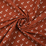 Algodón estampado con ancla azul marino blanca y fondo naranja quemado