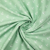 Algodón estampado con ancla marina blanca y fondo verde mar.