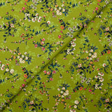 Cotton poplin printed with an idyllic flower on an apple green background