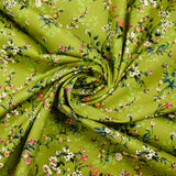 Cotton poplin printed with an idyllic flower on an apple green background