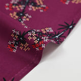 Cotton poplin printed with satellite flowers on a purple background