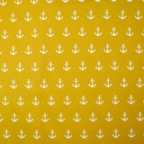 Cotton printed with white navy anchor, ocher background