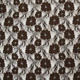 Martha metallic silver polyester lace with brown background