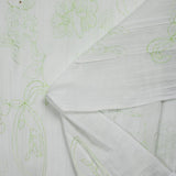 Crumpled polycotton and embroidered anise green flowers