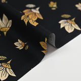 Cotton poplin printed pastel yellow flower and honey black background