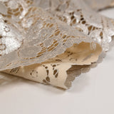 Silver laminated cotton guipure on an ecru background