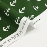 Cotton printed with white navy anchor, forest green background