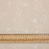 Voile de polyester brodé fleurs et feuillages beige