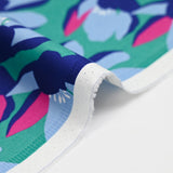 Cotton elastane satin blue flowers mint green background
