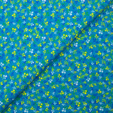 Cotton poplin printed yellow and blue bud with turquoise background