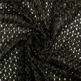Puntilla de poliéster calada con entrelazado de lurex dorado, fondo negro
