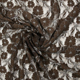 Martha metallic silver polyester lace with brown background
