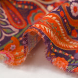 Cotton corduroy with orange paisley print and purple background