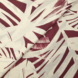 Cotton voile printed with traces of leaves, burgundy background