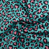 Pink leopard print cotton with turquoise background