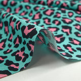 Pink leopard print cotton with turquoise background