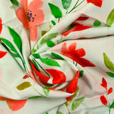 Viscosa estampada con flores rojas y fondo crudo.