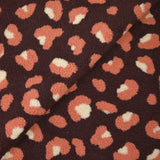Piel sintética de sherpa de leopardo color salmón y crudo, fondo ciruela oscuro