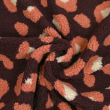 Piel sintética de sherpa de leopardo color salmón y crudo, fondo ciruela oscuro