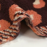 Piel sintética de sherpa de leopardo color salmón y crudo, fondo ciruela oscuro