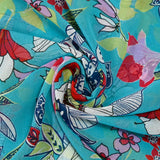 Mousseline imprimée fleurs exotiques rouge et blanc fond turquoise