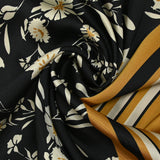 Twill de polyester satiné imprimé fleurs écrues et bordure ocre fond noir
