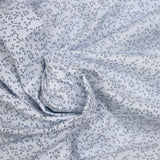 Polycotton poplin printed with navy grove and white sky background