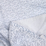 Polycotton poplin printed with navy grove and white sky background