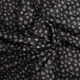 Polycotton poplin printed with flowers on black background