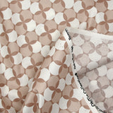 Coated poplin printed with white polka dots & clover on a glossy brown background