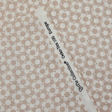 Popeline enduite imprimée champs de fleurs beige fond blanc