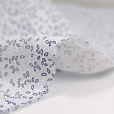 Polycotton poplin printed with navy grove and white sky background