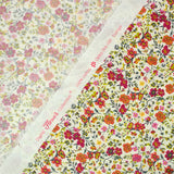 Coton imprimé Greta fleurs fuchsia et orange fond blanc au mètre