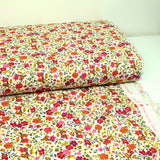 Coton imprimé Greta fleurs fuchsia et orange fond blanc au mètre
