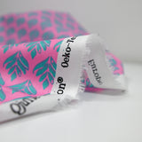 Coated poplin with green plant print, pink background