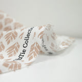 Coated poplin with beige vegetable print on off-white background