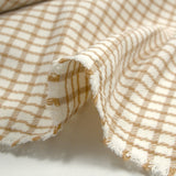 Polyester elastane with camel checkered off-white background