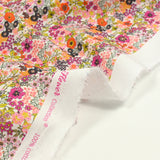 Flores de estampado de algodón Matilde Naranja y fucsia por metro
