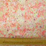 Silk satin printed with coral pink flowers on a pastel green background