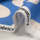 Viscose satin printed with ecru waves and sky background
