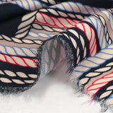 Viscose satin printed with blue and red ropes, navy background
