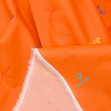 Cotton sports print with orange background