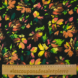 Viscose printed with squiggles of flowers on a black background