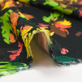 Viscose printed with squiggles of flowers on a black background