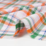 Woven cotton-tight Rowan green and orange white background