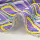 Viscose satin with retro disco print, purple background